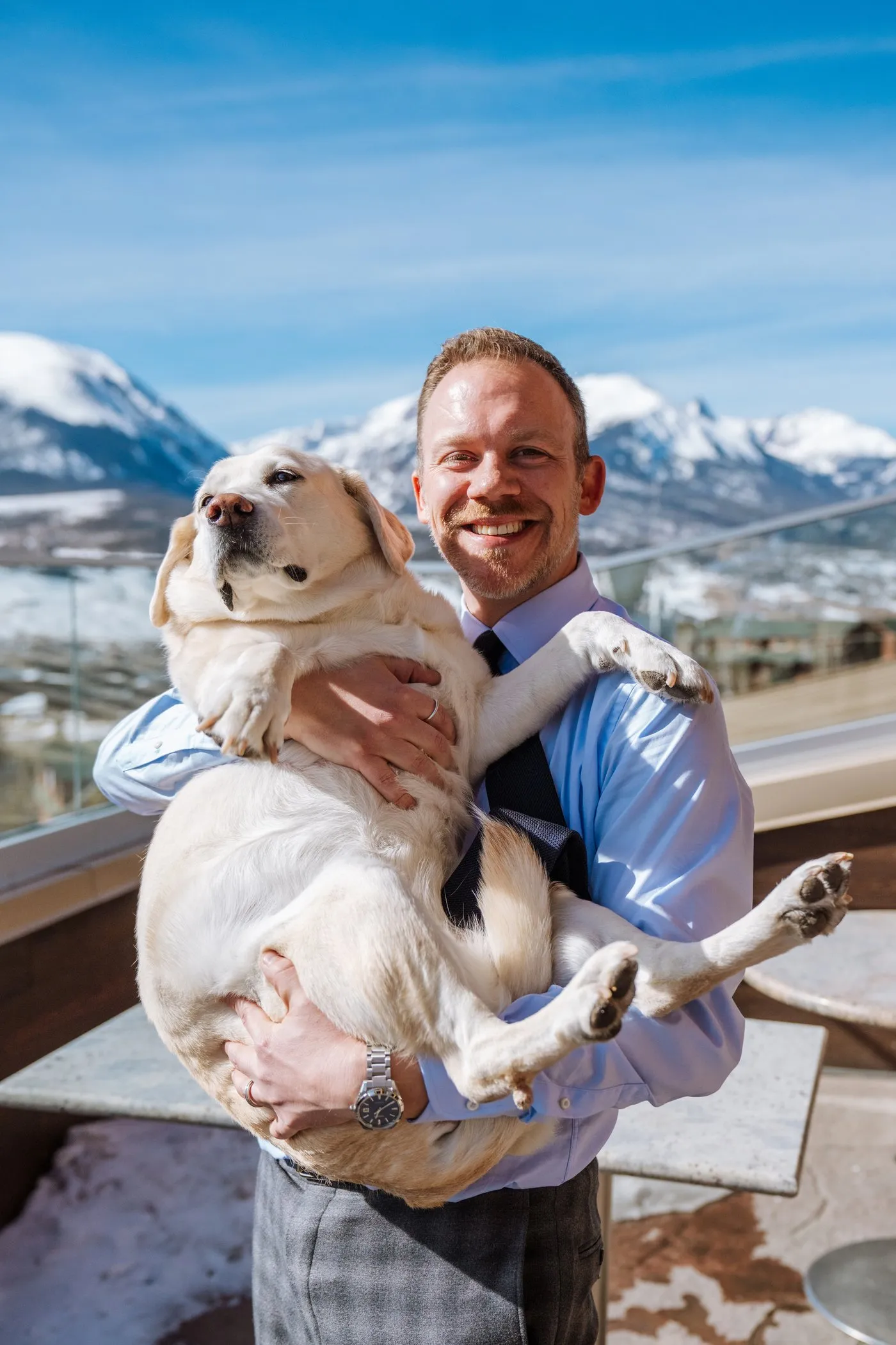 Joshua Taylor, Enrolled Agent, holding Honey with Colorado mountains behind